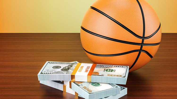 A basketball and some money on top of a table.